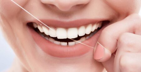 closeup beautiful snow white smile strong white teeth teethcare healthcare stomatological concept dentists cleaning teeth with tooth thread ()