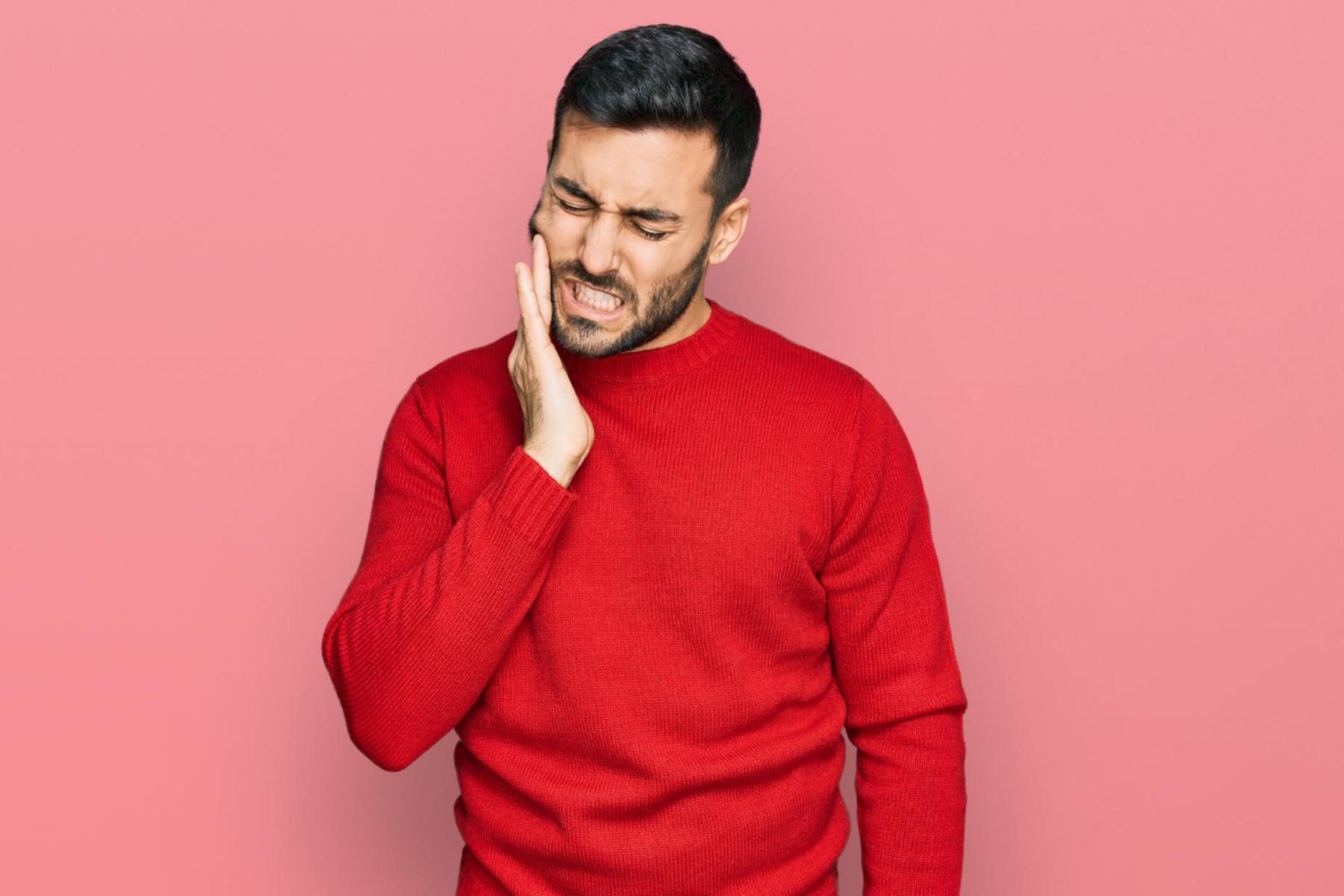 man with persistant tooth throb and pain