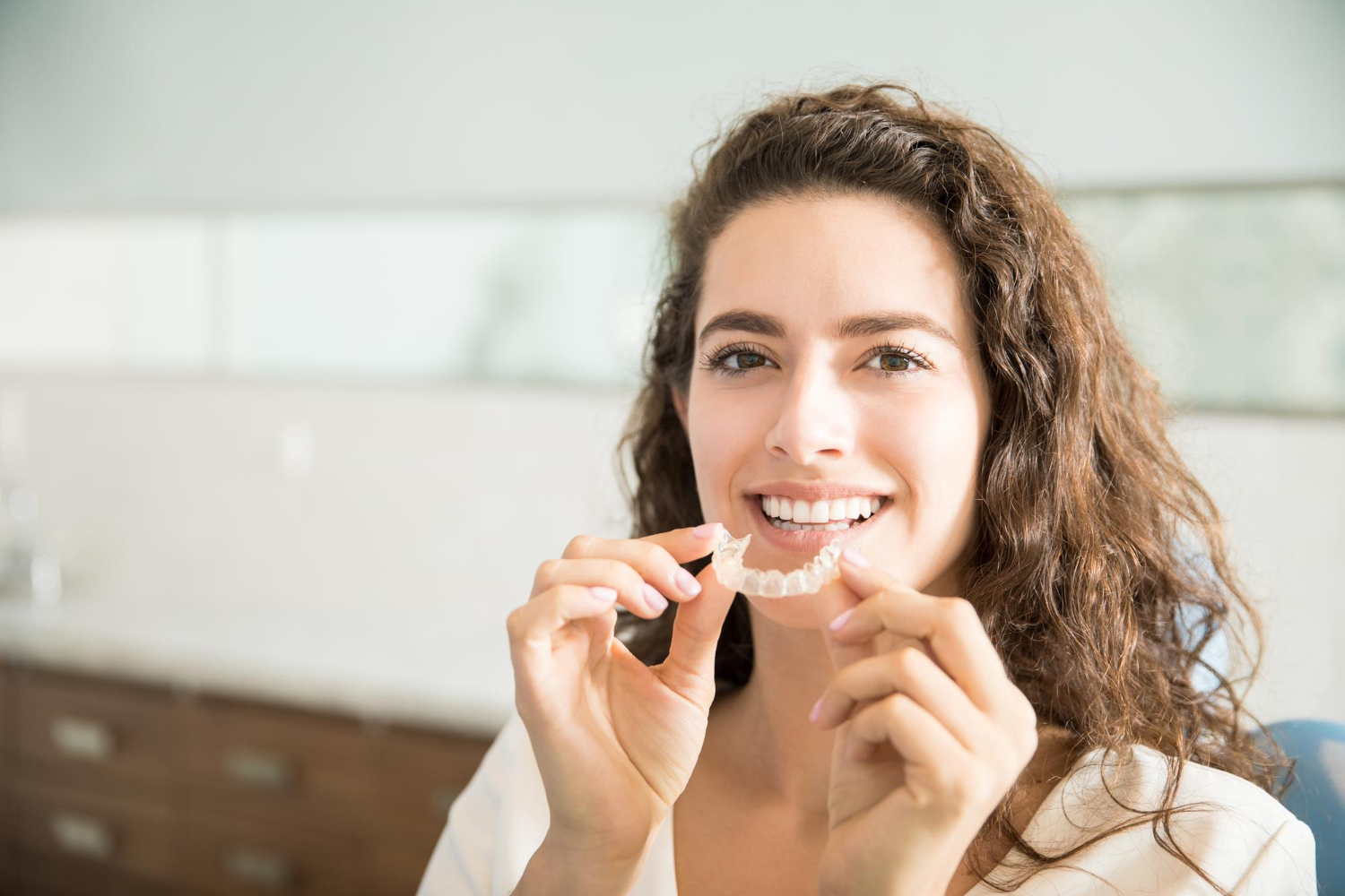 patient holding orthodontic retainers dental clinic