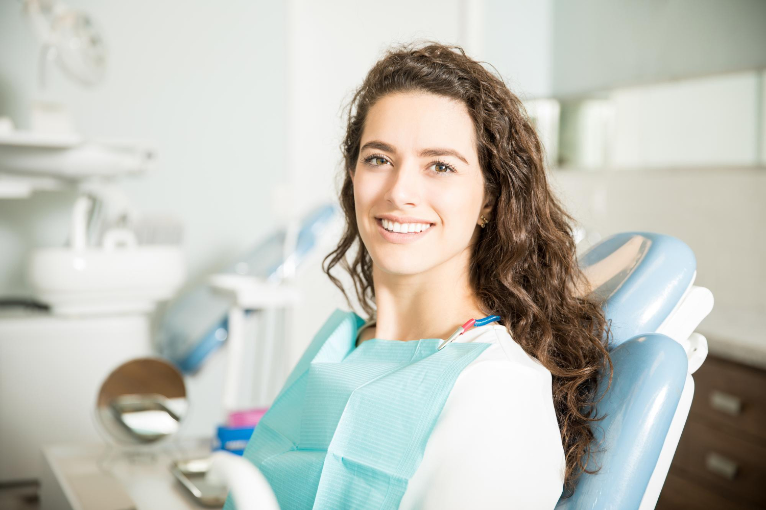 smiling young woman sitting chair dental clinic