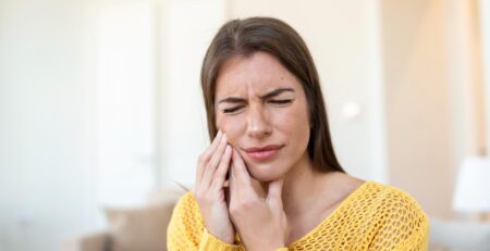 tooth pain dentistry beautiful young woman suffering from terrible strong teeth pain touching cheek with hand female feeling painful toothache dental care health concept high resolution
