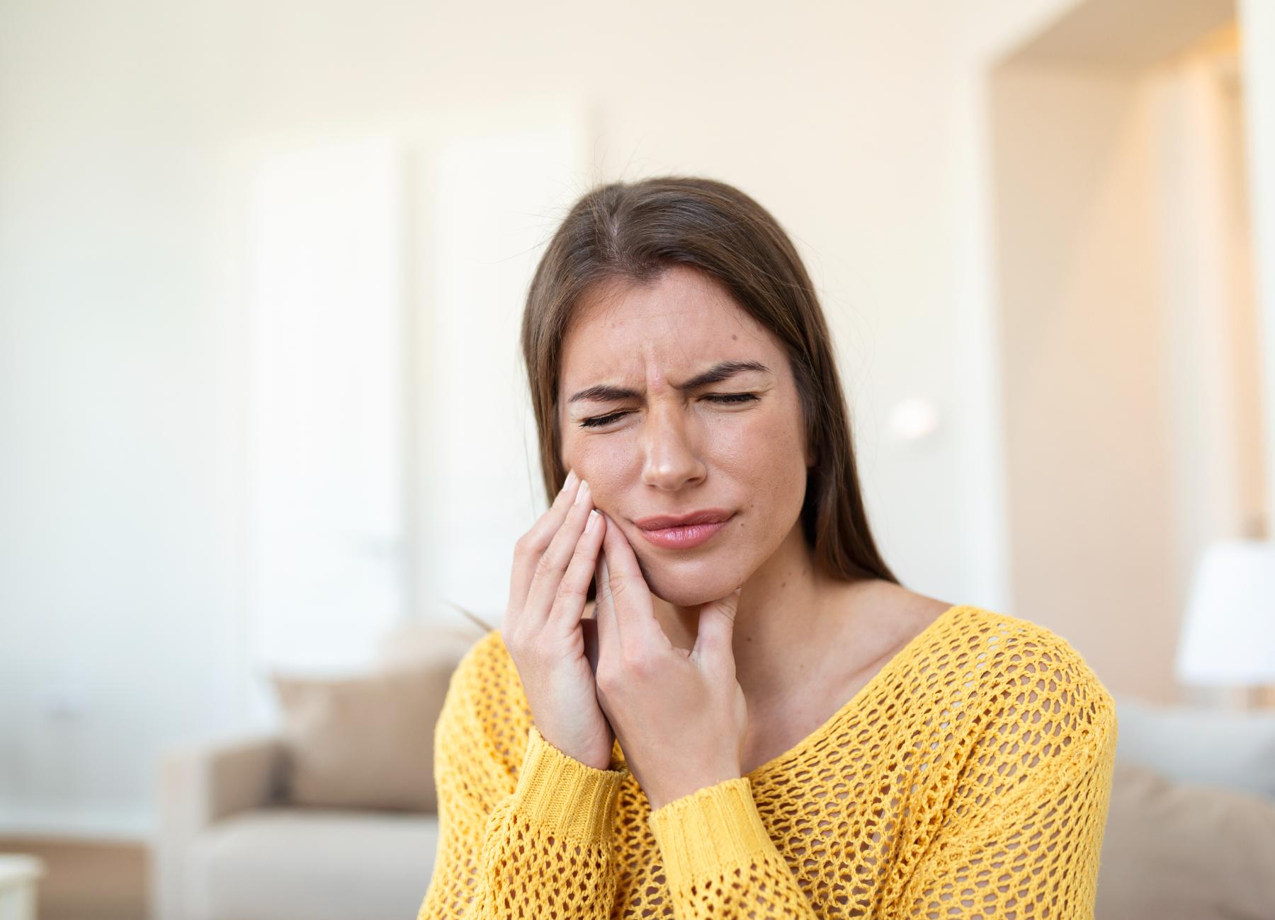 tooth pain dentistry beautiful young woman suffering from terrible strong teeth pain touching cheek with hand female feeling painful toothache dental care health concept high resolution
