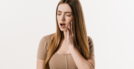 woman experiencing tooth pain