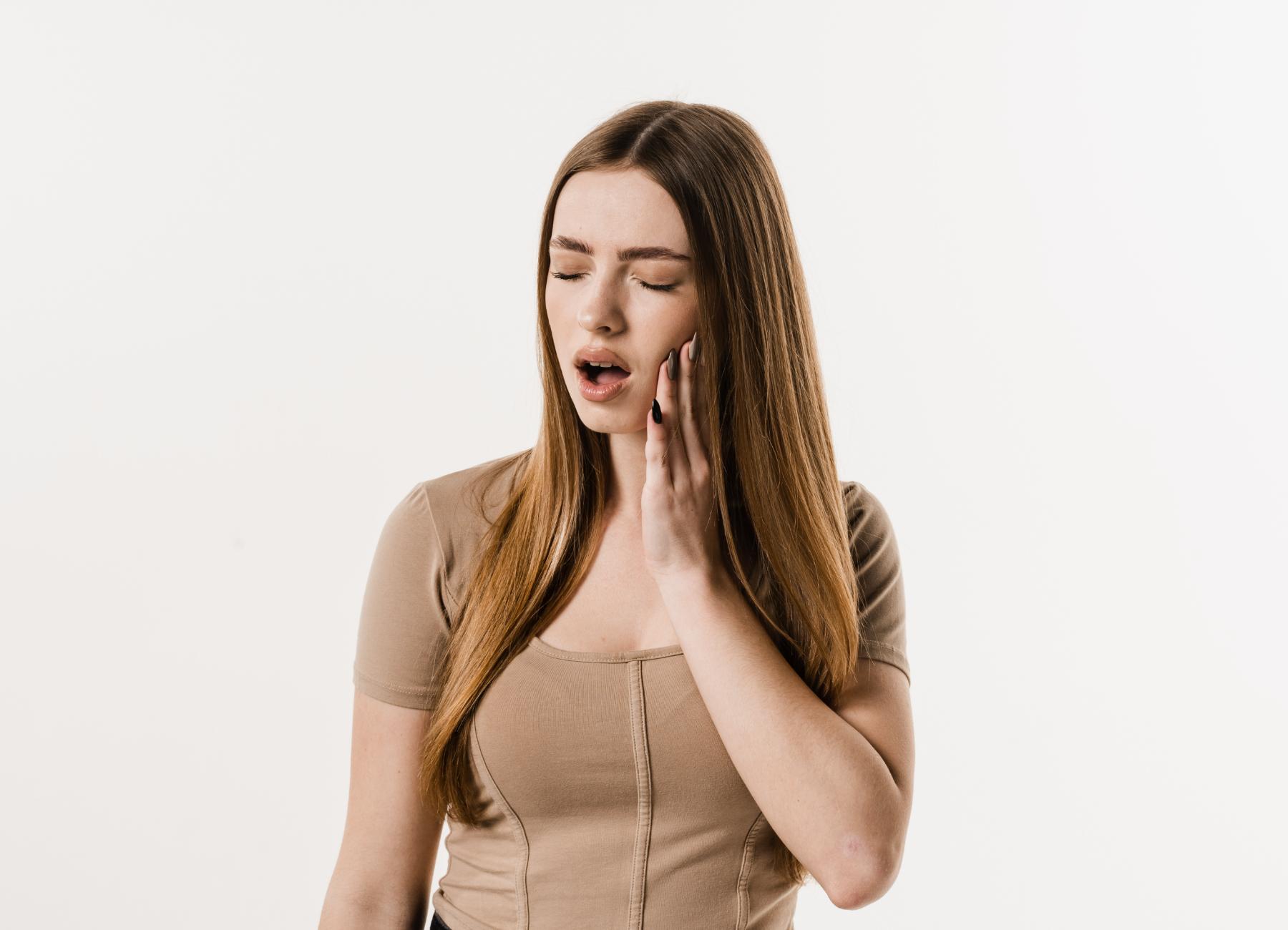 woman experiencing tooth pain